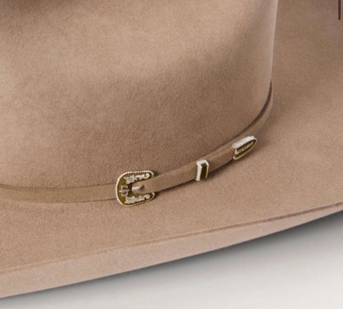 Close-up of a brown hat with a strap and buckle