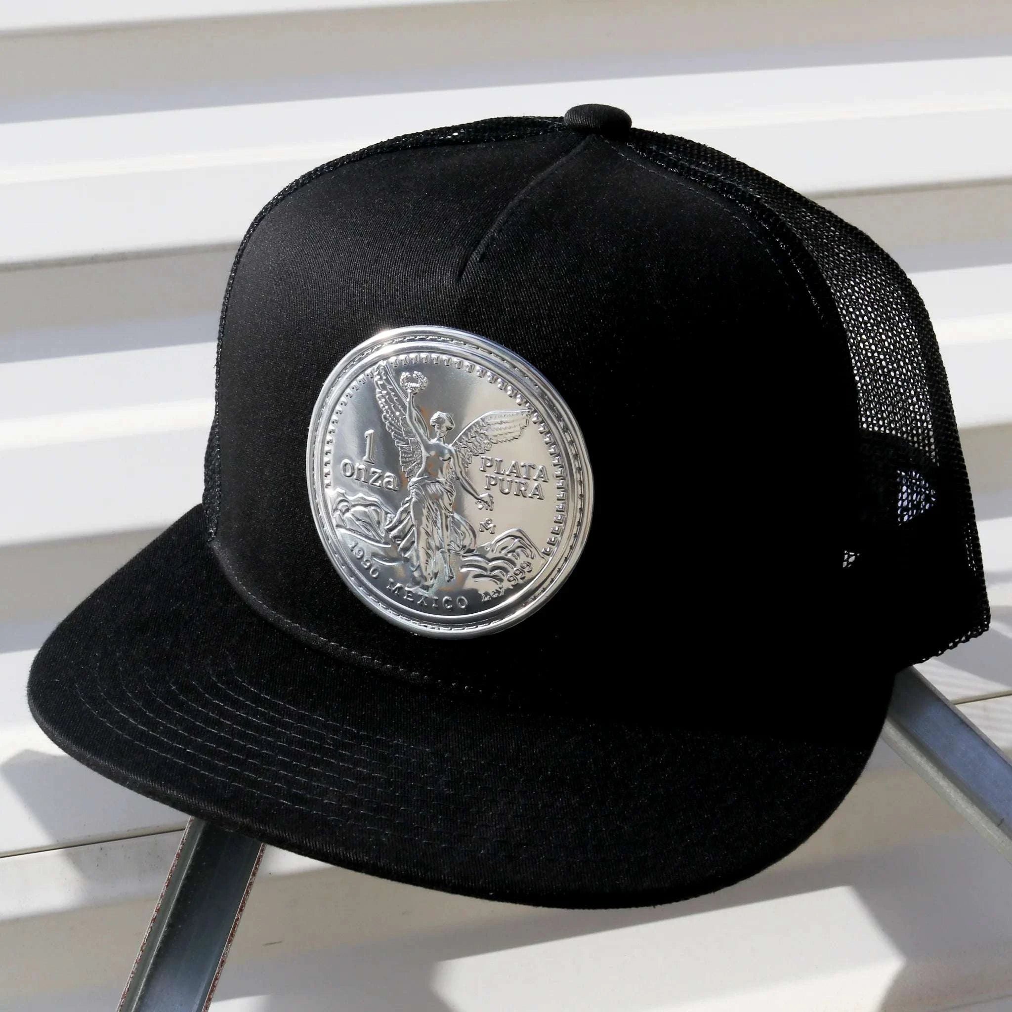 Black cap with a silver coin emblem