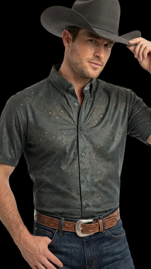 Man wearing a dark green patterned shirt, jeans, and a cowboy hat