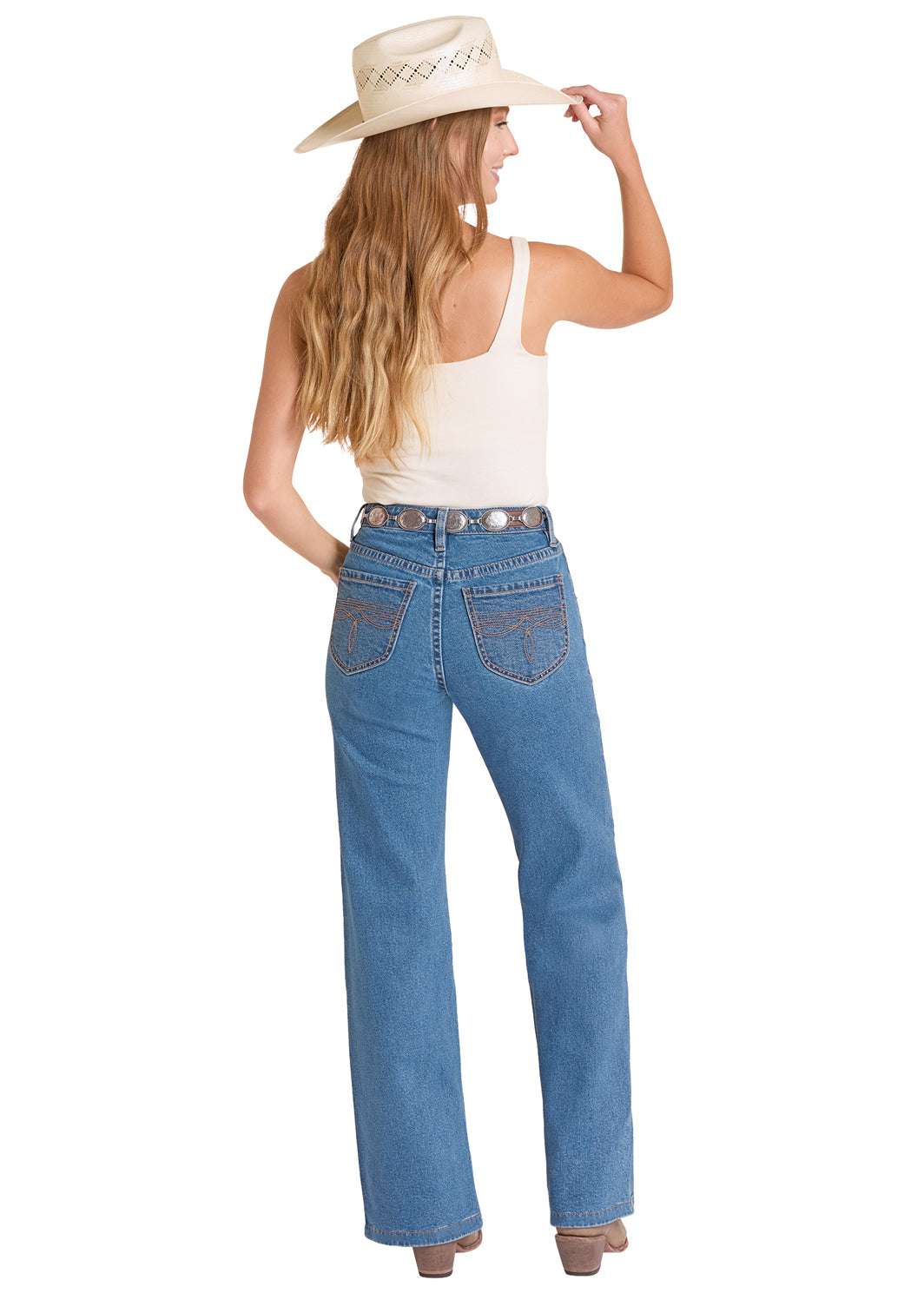 Woman wearing blue jeans and a white tank top with a cowboy hat