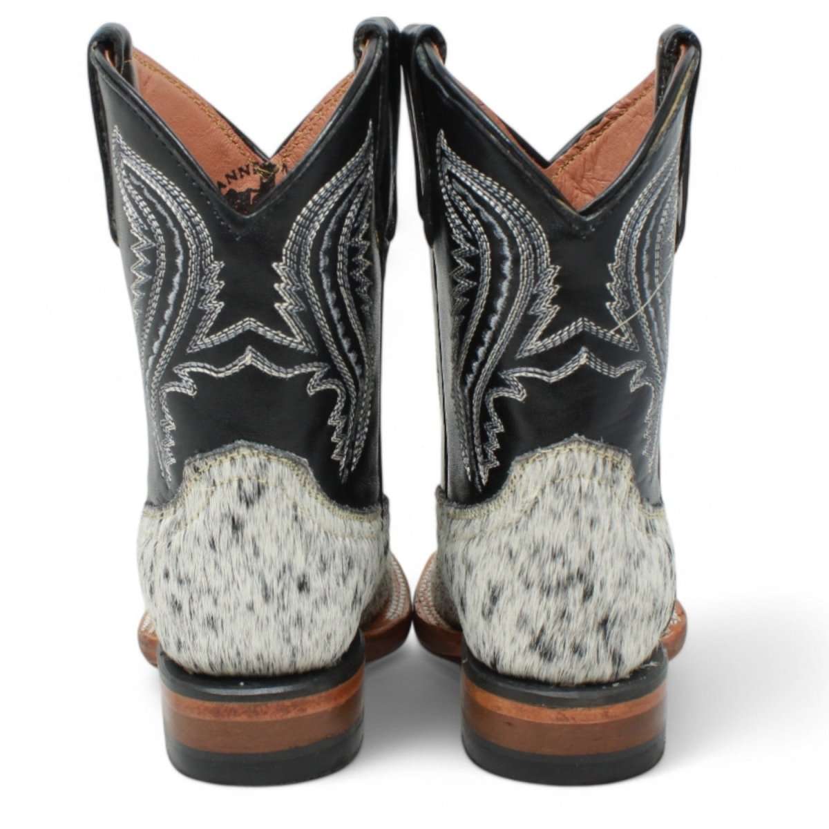 Pair of black and brown cowboy boots with intricate designs