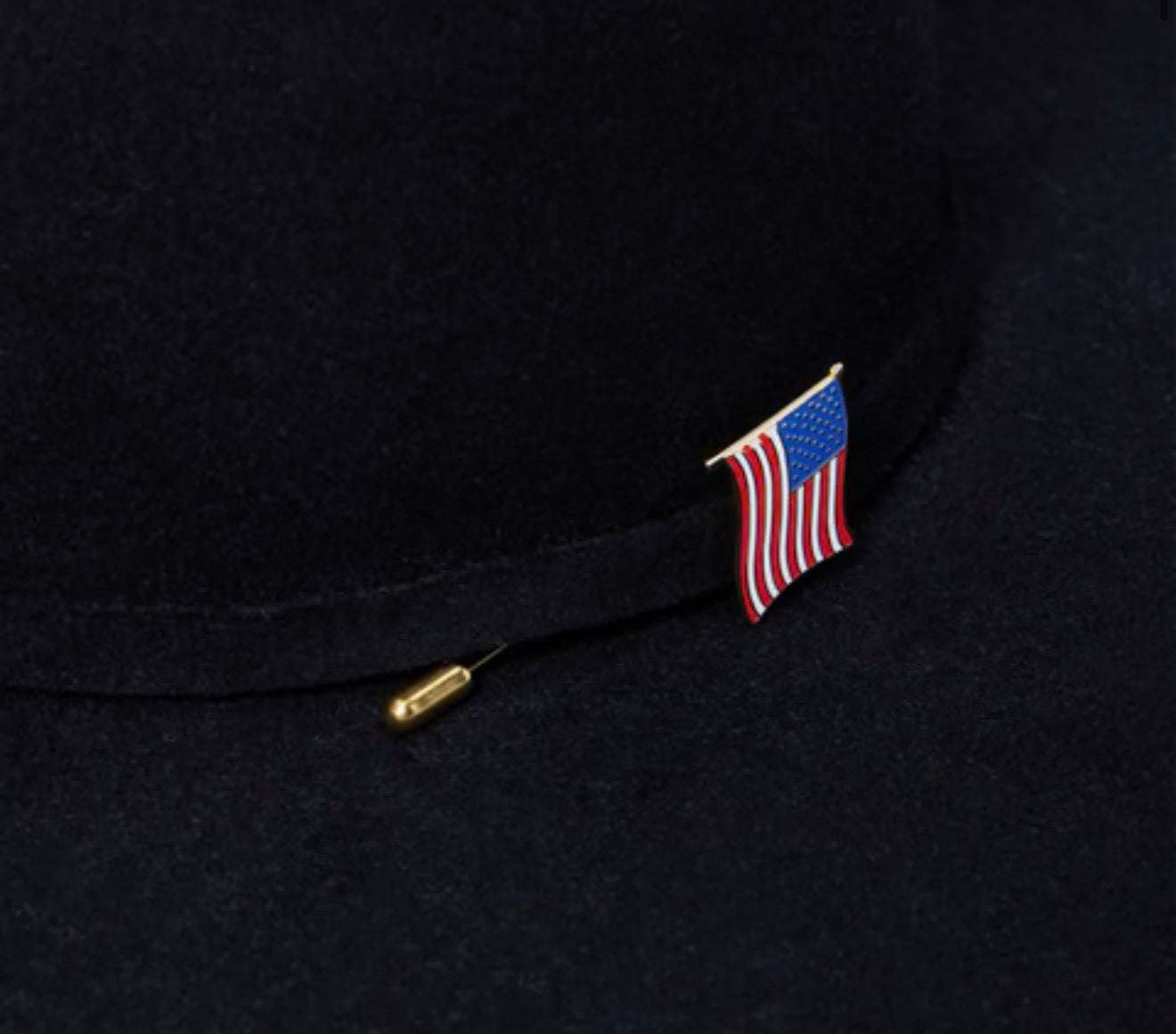 American flag lapel pin on a black suit