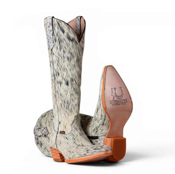A pair of western cowboy boots with a gray and white mottled hair-on-hide upper, shown from the back on a white background. One boot is upright to show the pointed toe and tan pull tab, while the other lies flat to show the sole.