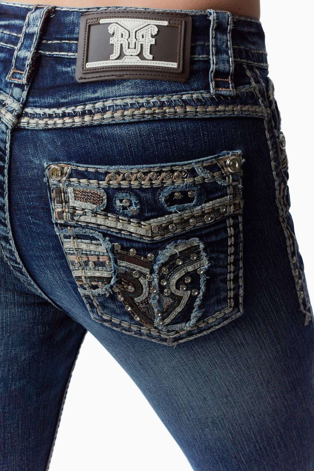 Close-up of blue jeans with decorative pocket and brand patch