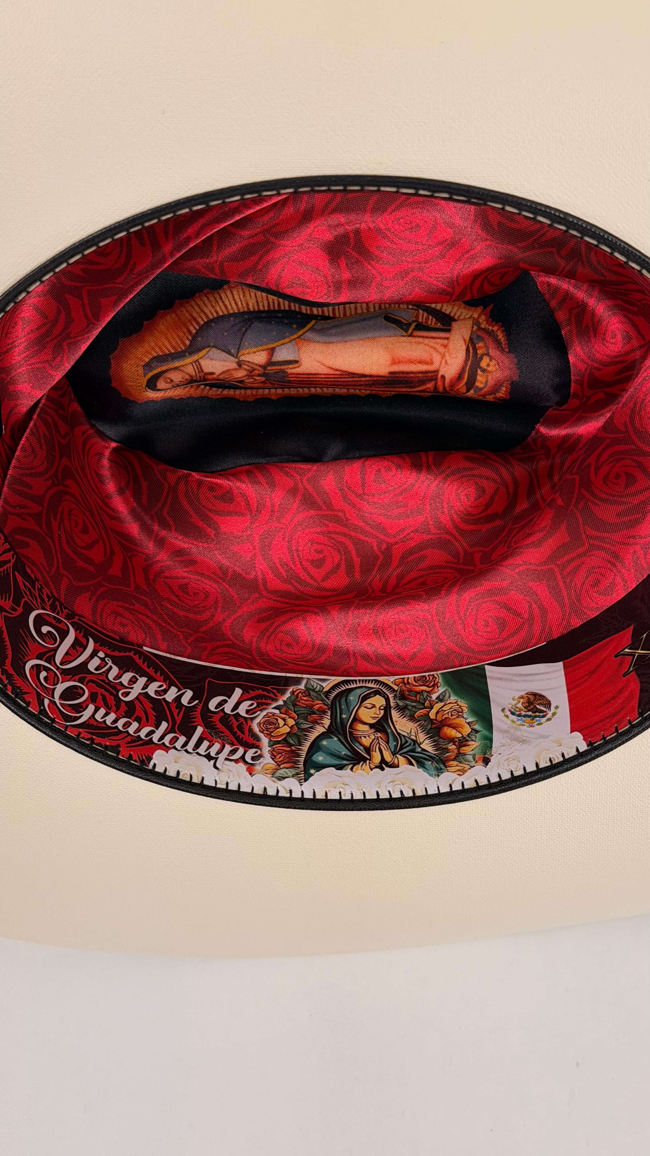 Red satin bag with a religious icon and text 