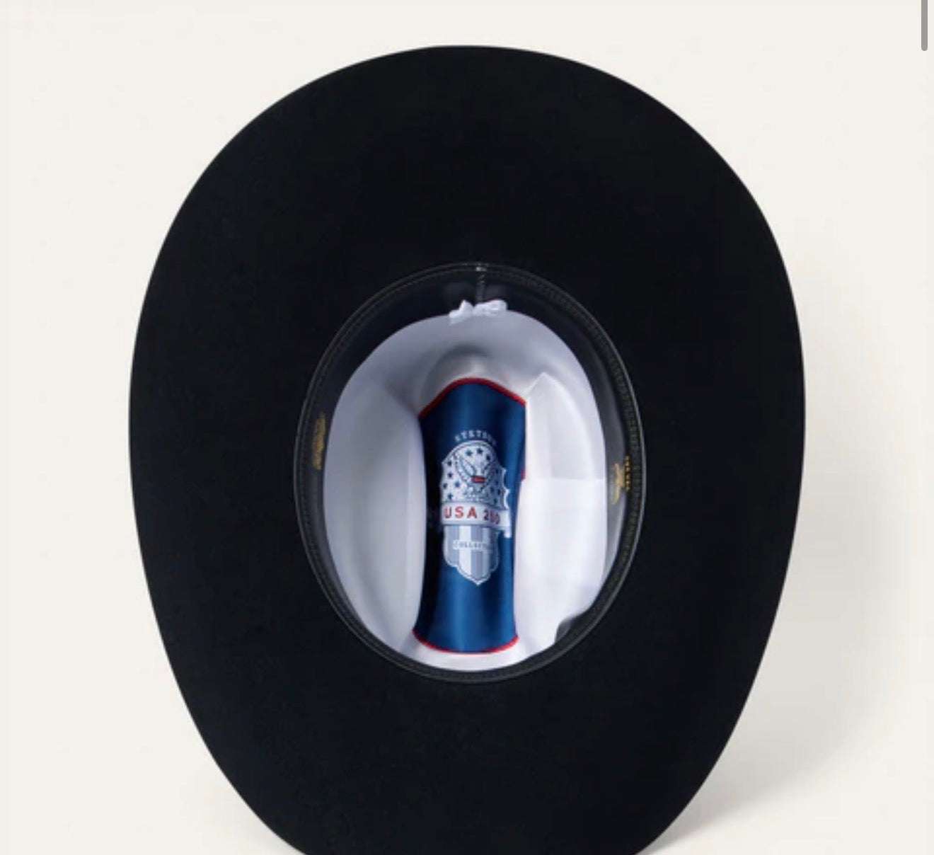 Black cowboy hat with a visible brand label 