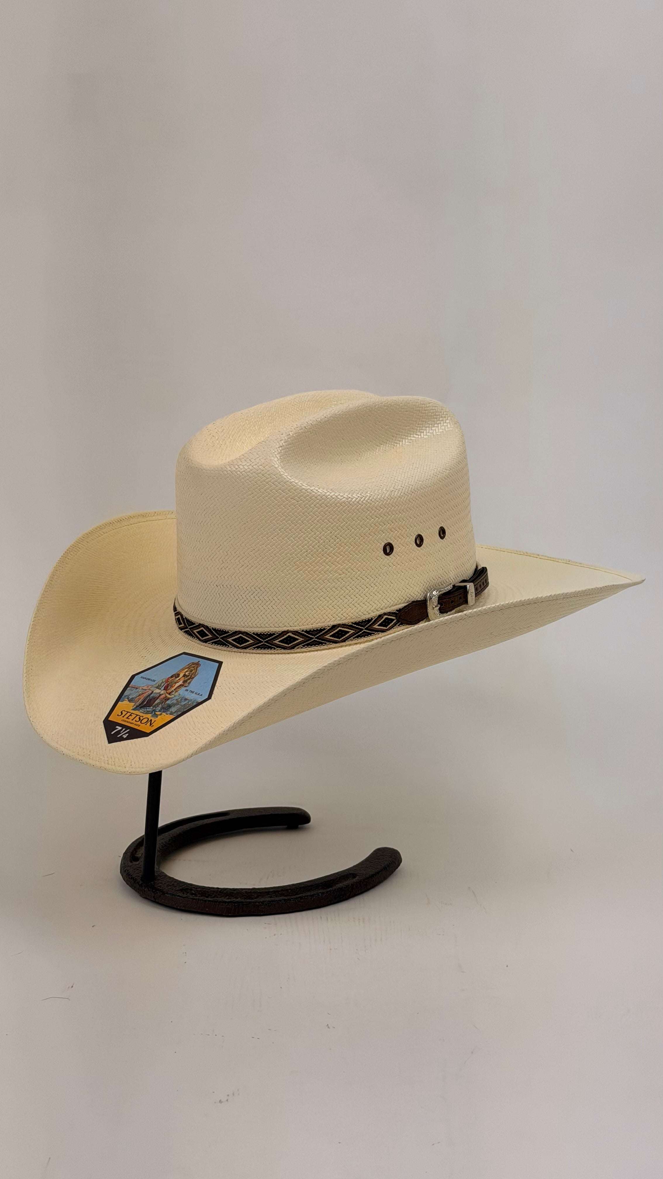 Beige cowboy hat with a decorative band 