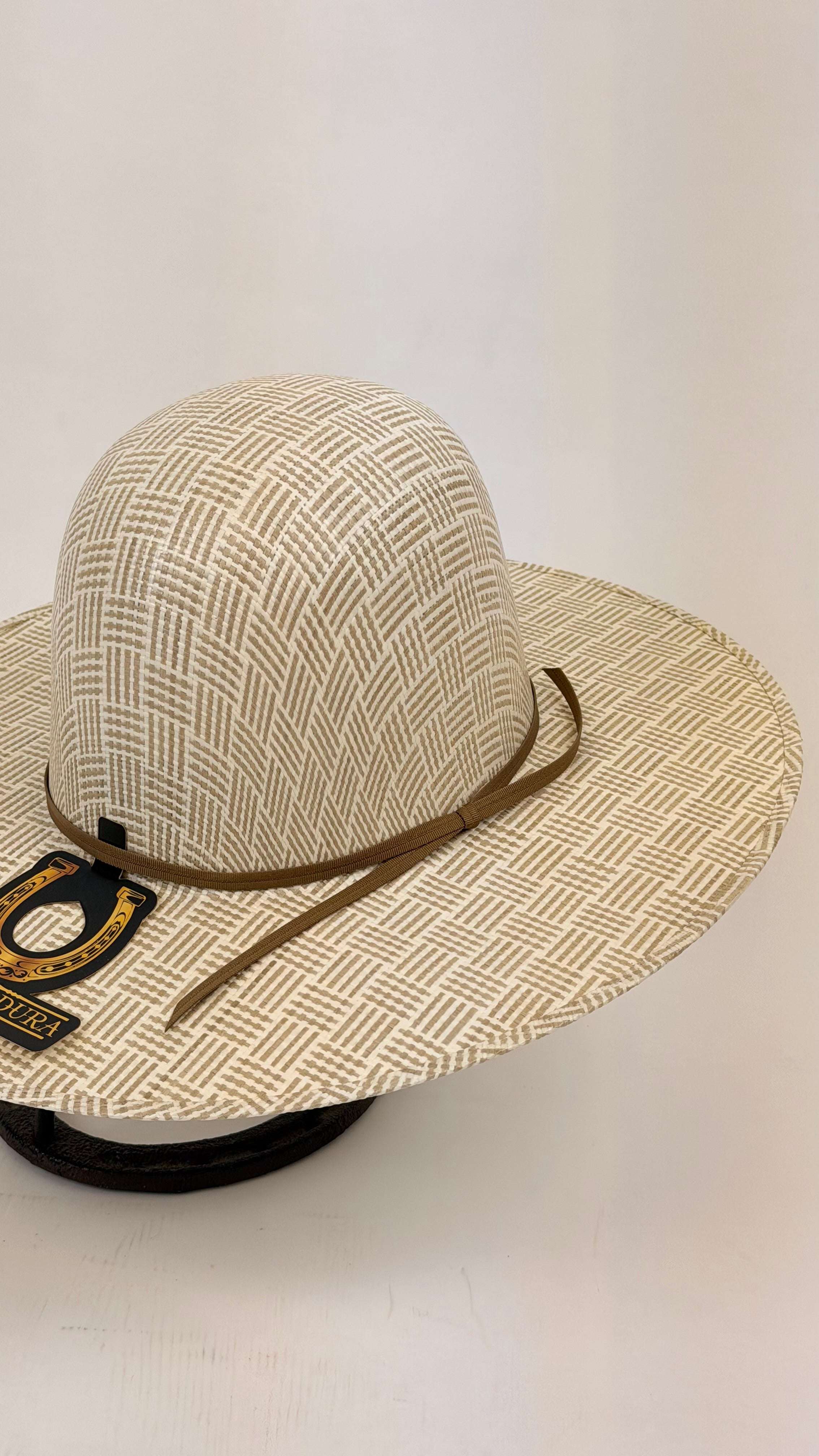 Beige sun hat with a patterned band on a white background