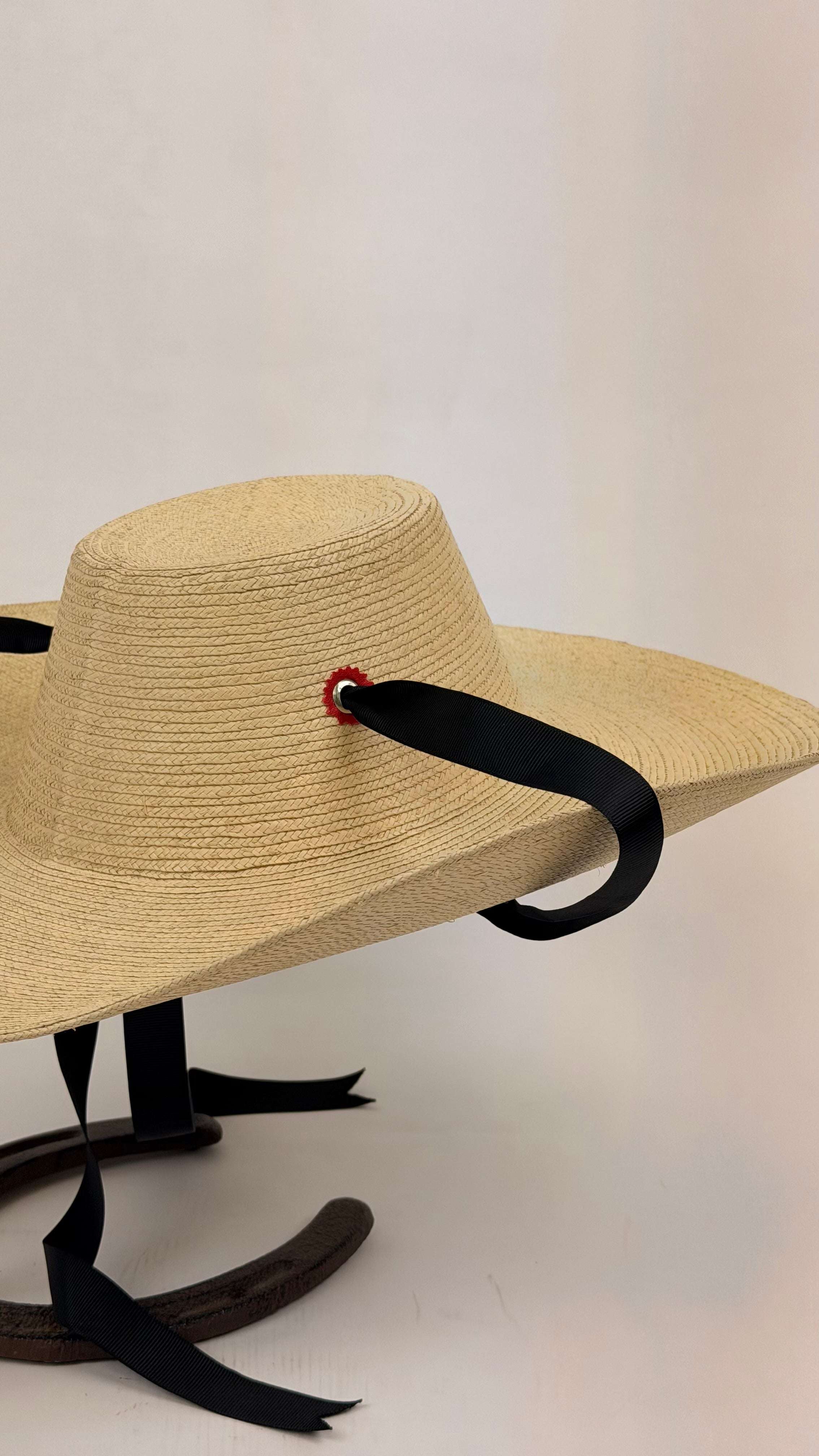 Beige straw hat with black ribbon 

