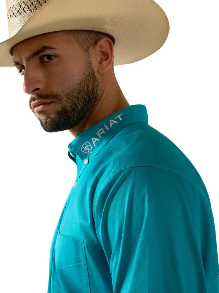 Man wearing a turquoise Ariat shirt